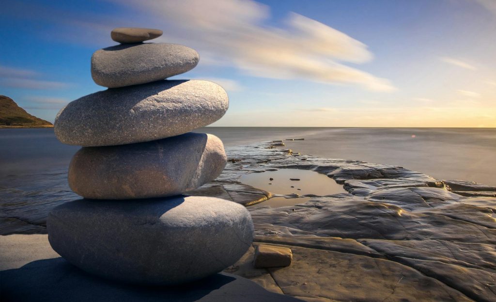 Close-up of smooth rocks symbolizing stability and grounding in Crawley, London